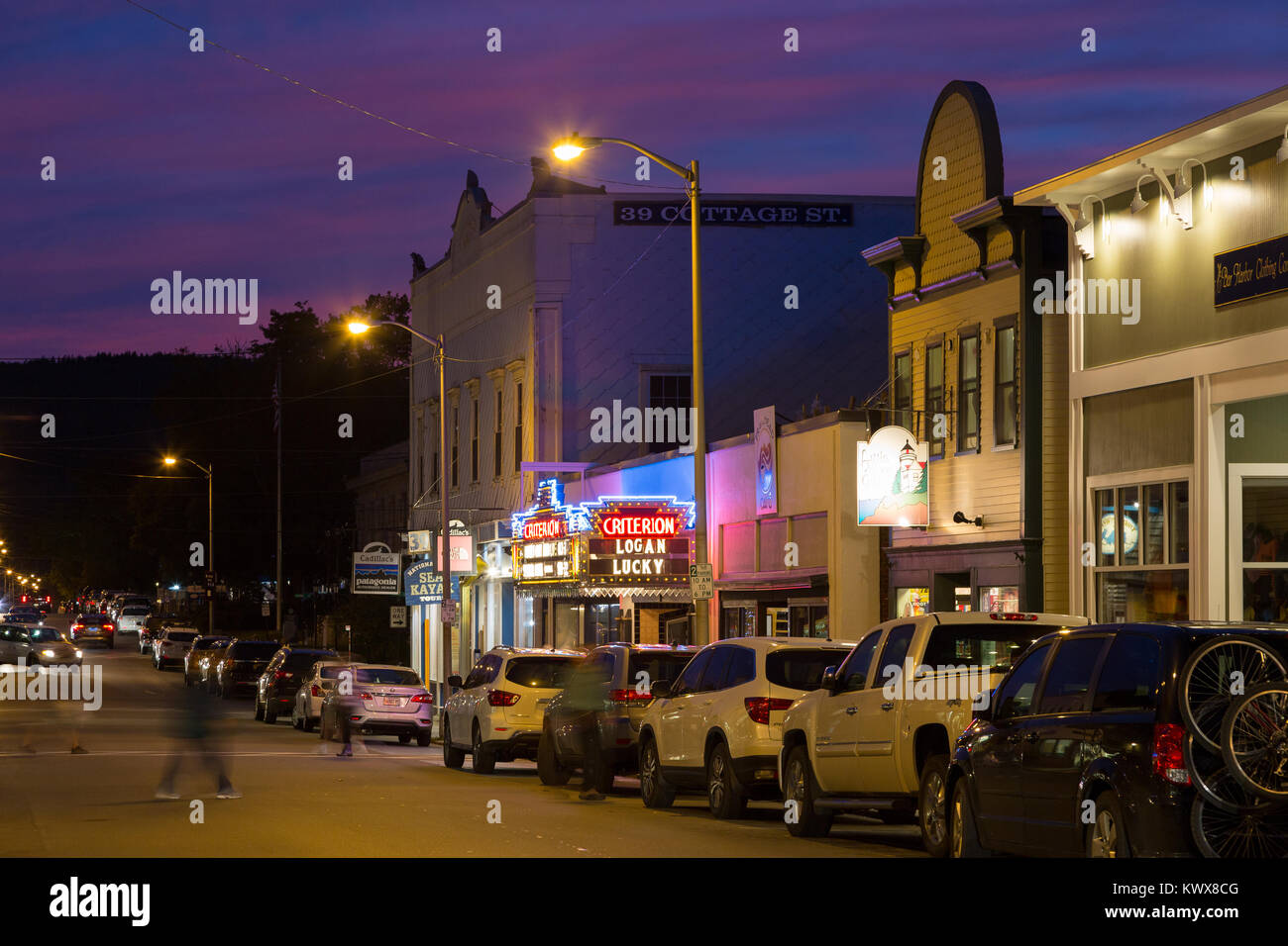 The old Criterion Theater lit up among other shops and commercial entities. Bar Harbor, Maine Stock Photo