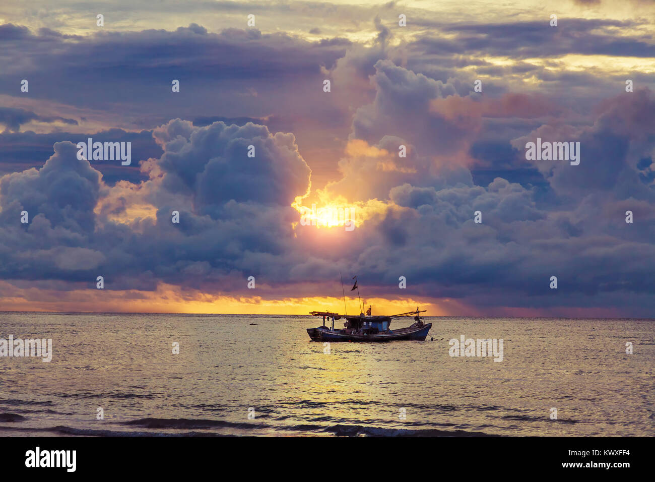 beautiful sunset over the old fishing boat Stock Photo - Alamy