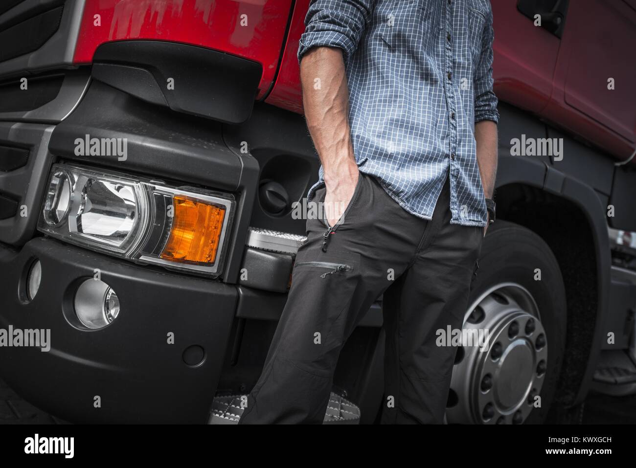 Semi Truck Driver Job. Caucasian Trucker in Front of His Truck. Closeup Photo. Stock Photo