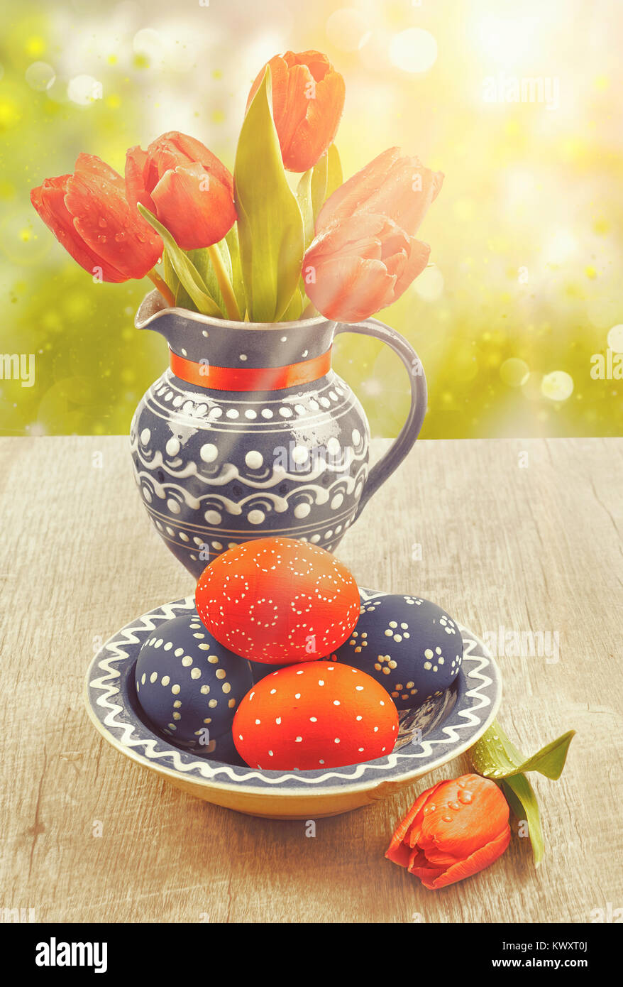Case with tulips and painted Easter Eggs on abstract spring background ...