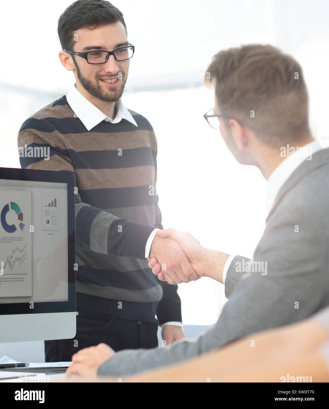 handshake Manager and the client in the office Stock Photo - Alamy