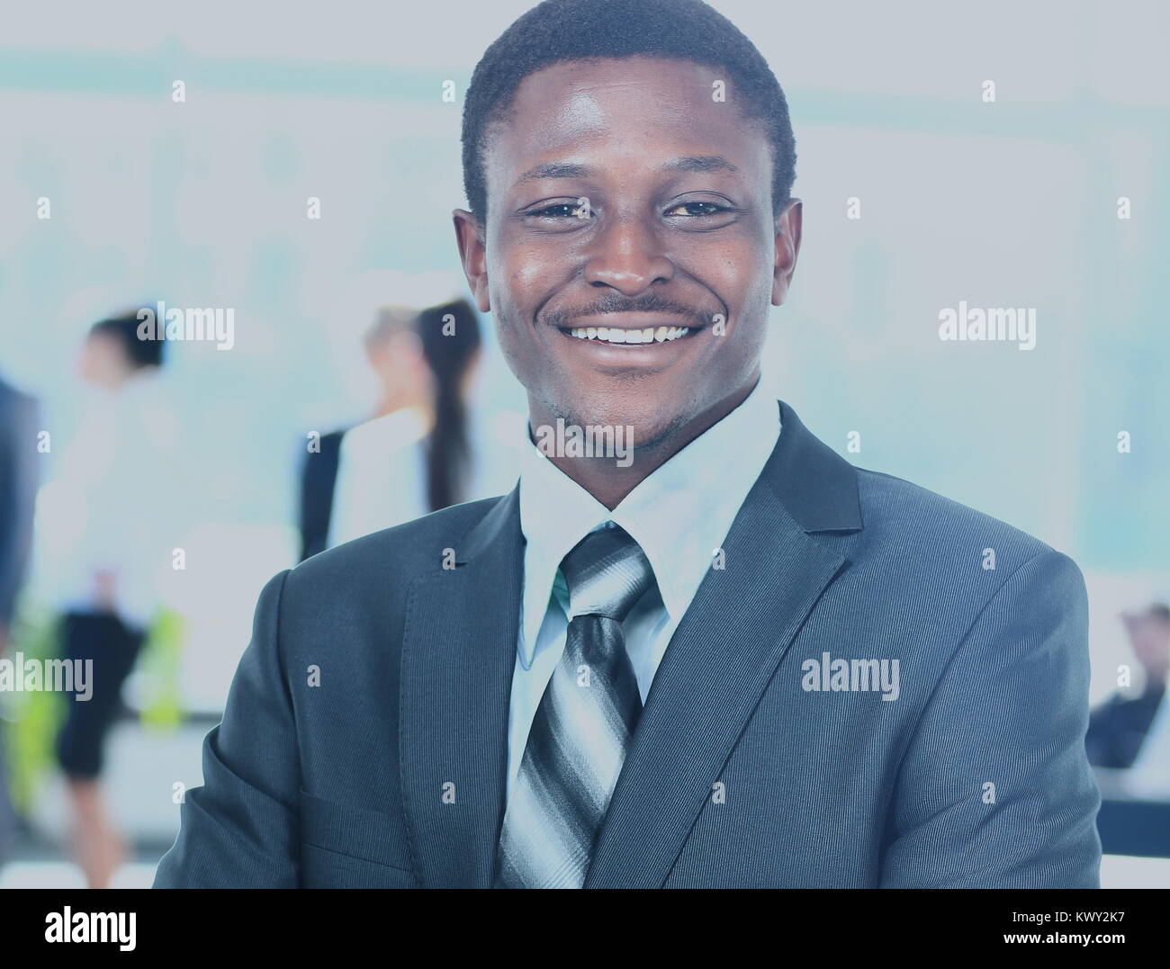 Confident business man with his team behind Stock Photo - Alamy