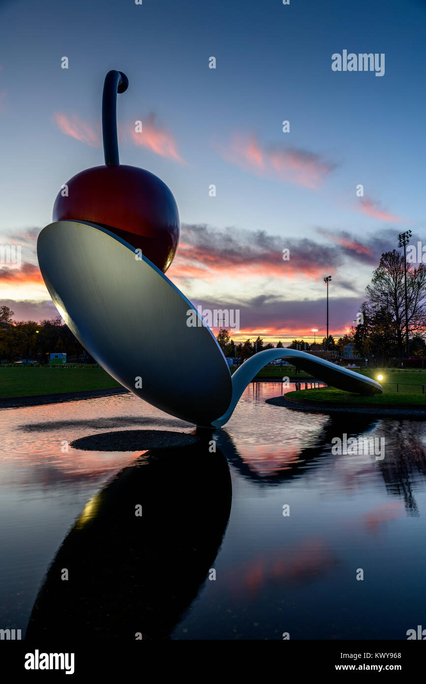 Spoonbridge and Cherry sculpture at night. Designed by Claes Oldenburg and his wife, Coosje van Bruggen. The complex fabrication of the 5,800 pound sp Stock Photo