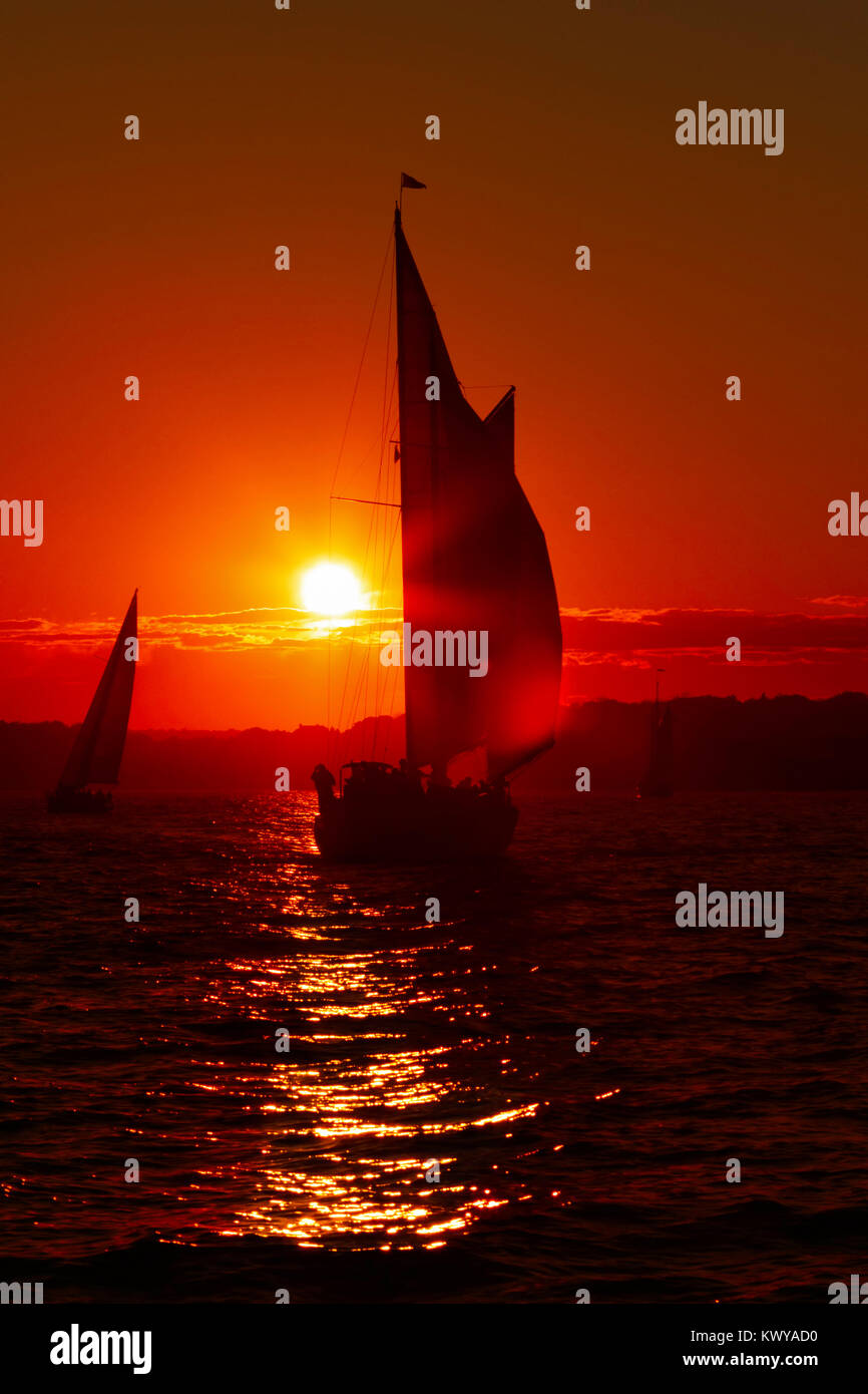 Sail boat at sunset on the ocean Stock Photo - Alamy