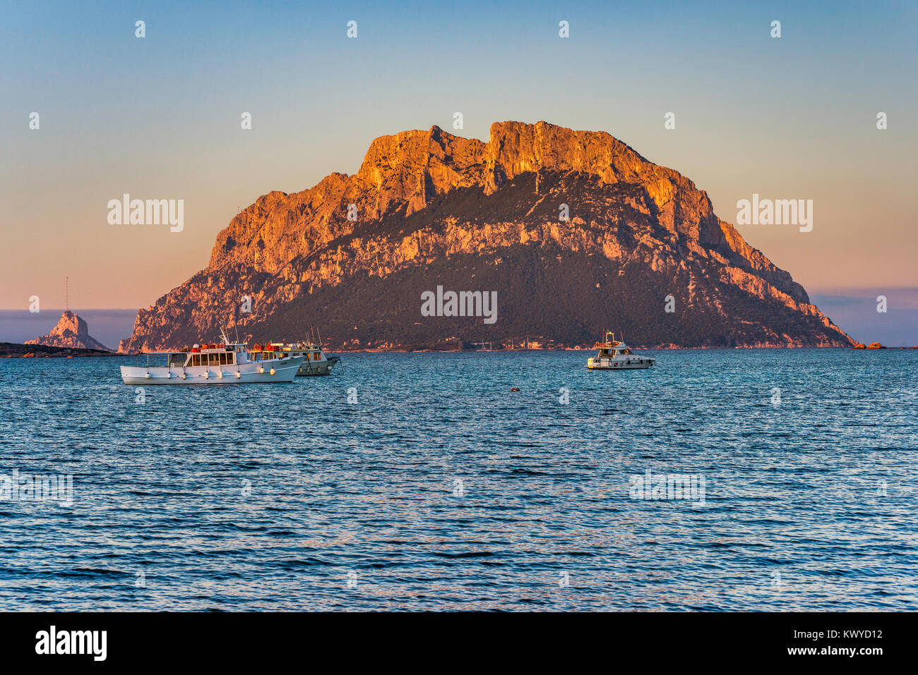 Isola Tavolara, boats, view at sunset from quay at Porto San Paolo, Mediterranean Sea, Gallura region, Sassari province, Sardinia, Italy Stock Photo