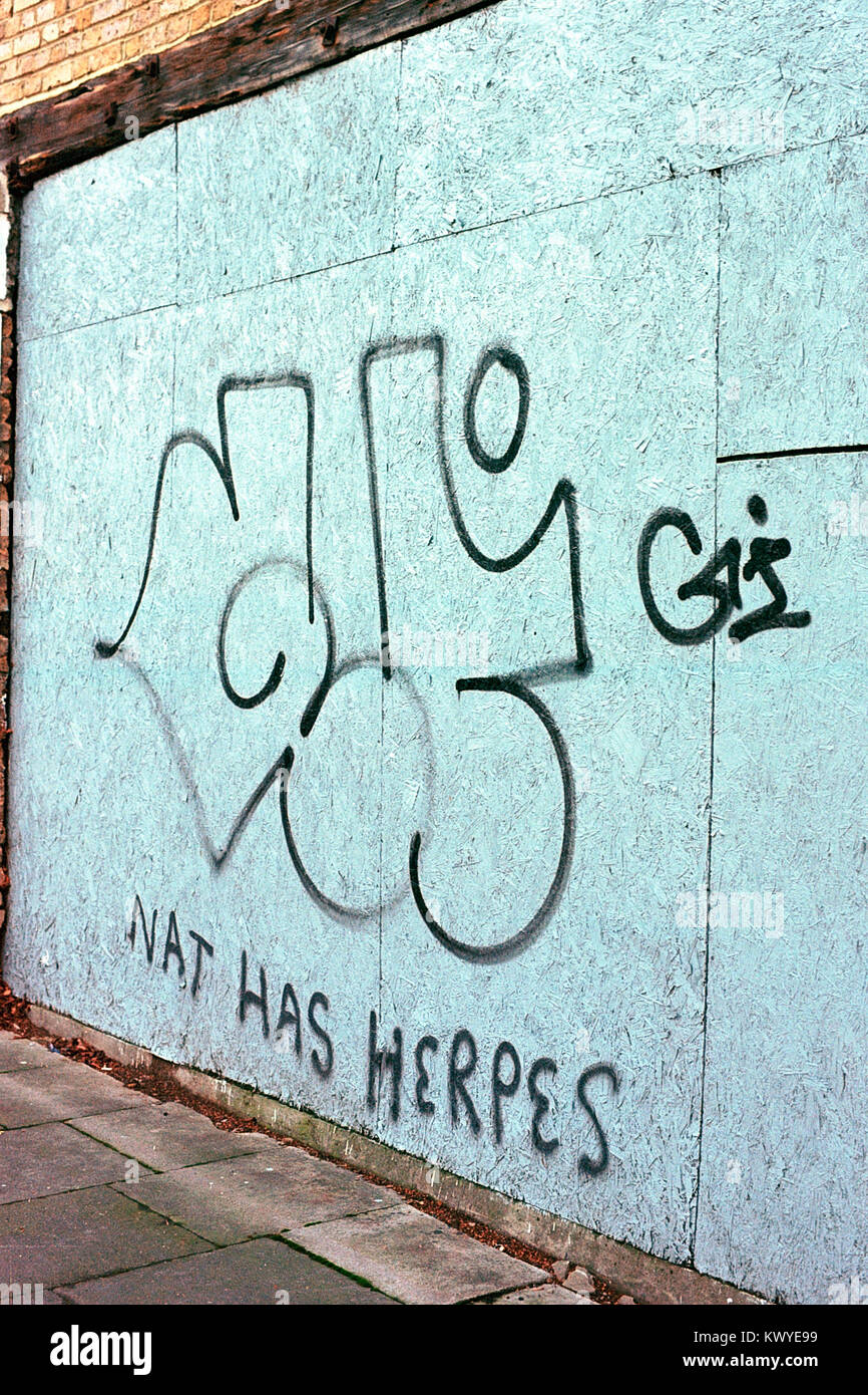 'Nat Has Herpes' graffiti on hoardings in Bow, east London. Stock Photo