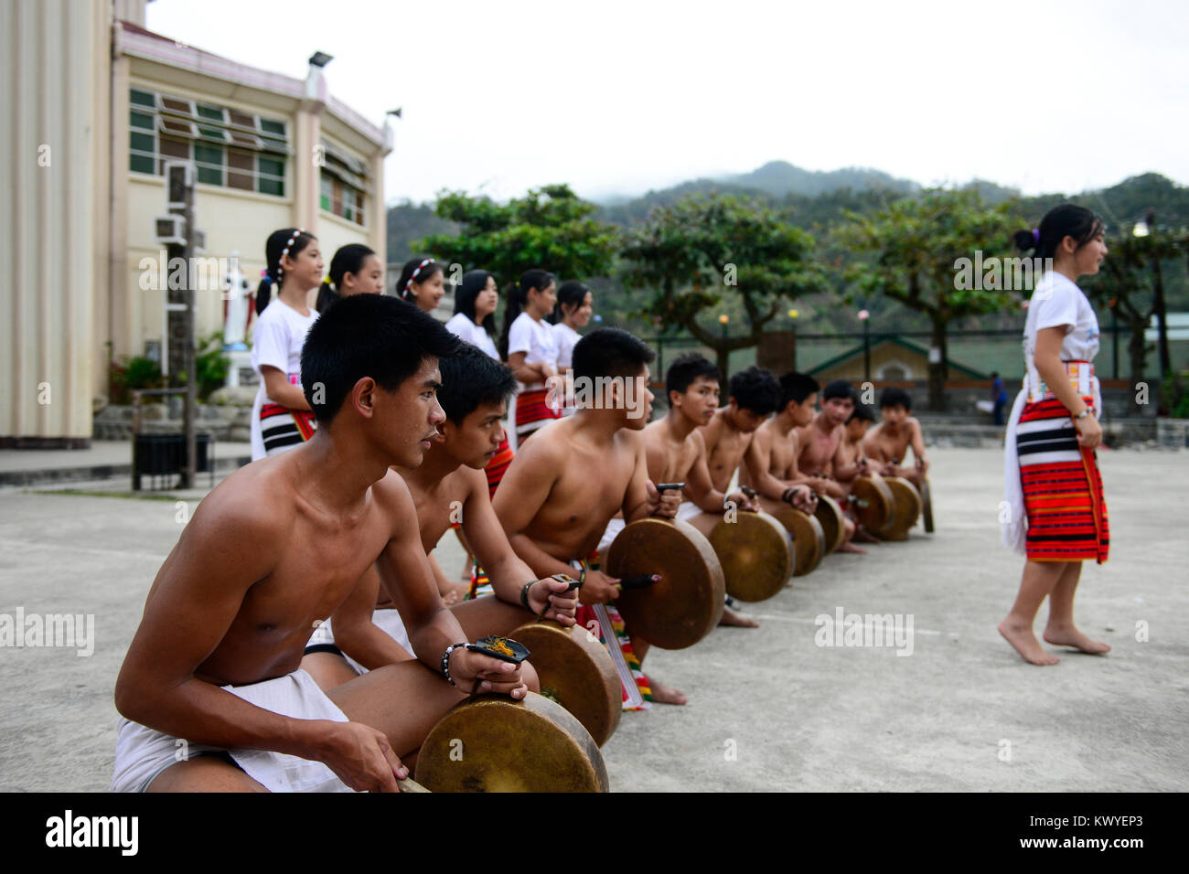 PHILIPPINES, Mountain Province, Cordilleras, Bontoc, youth group performes traditional tribal dance of Igorot culture in front of church Stock Photo