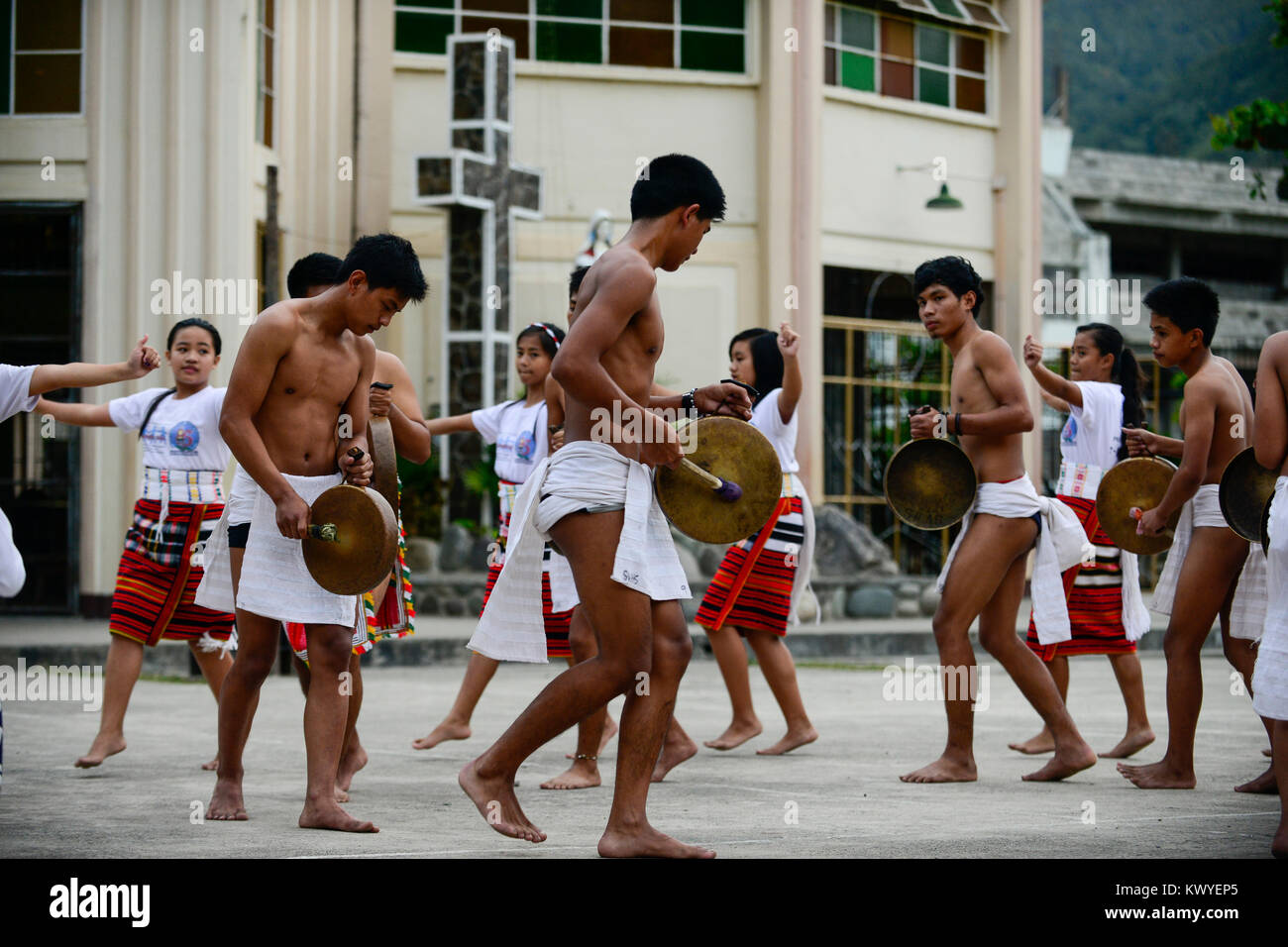 PHILIPPINES, Mountain Province, Cordilleras, Bontoc, youth group performes traditional tribal dance of Igorot culture in front of church Stock Photo
