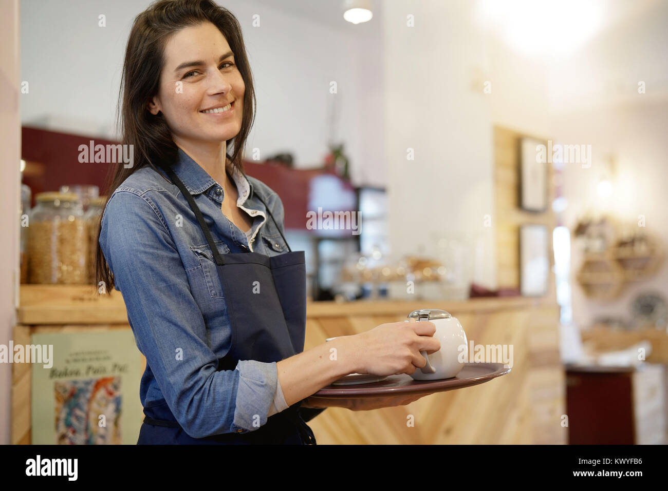 Waitress in coffee shop holding tray Stock Photo Alamy