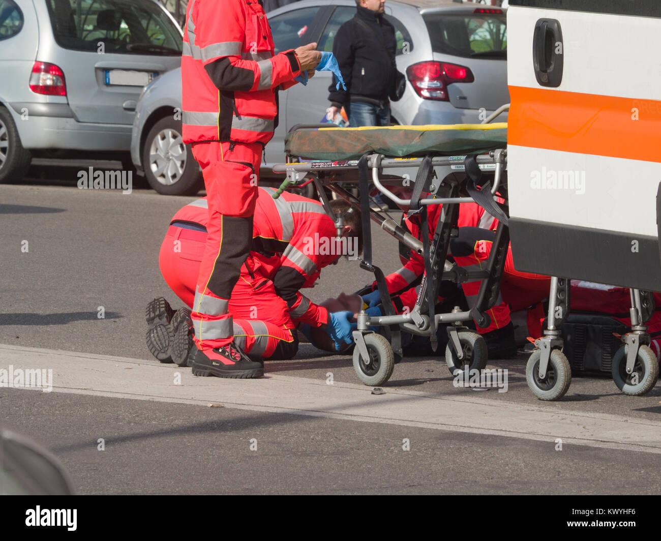 paramedics rescued a guy who had a motorcycle accident with his motorcycle, before loading it on the ambulance Stock Photo