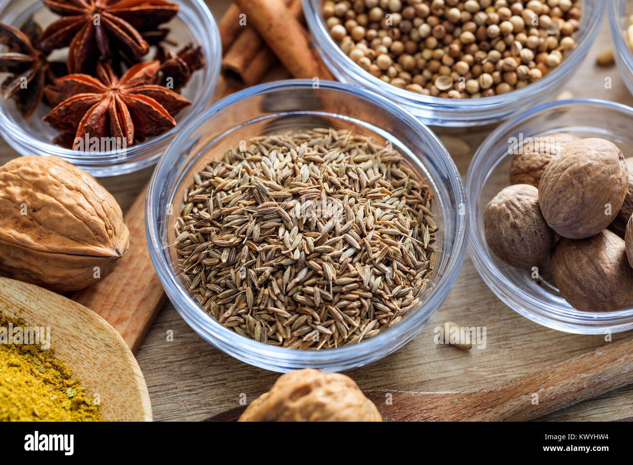 Cumin and other spices on a wooden surface Stock Photo
