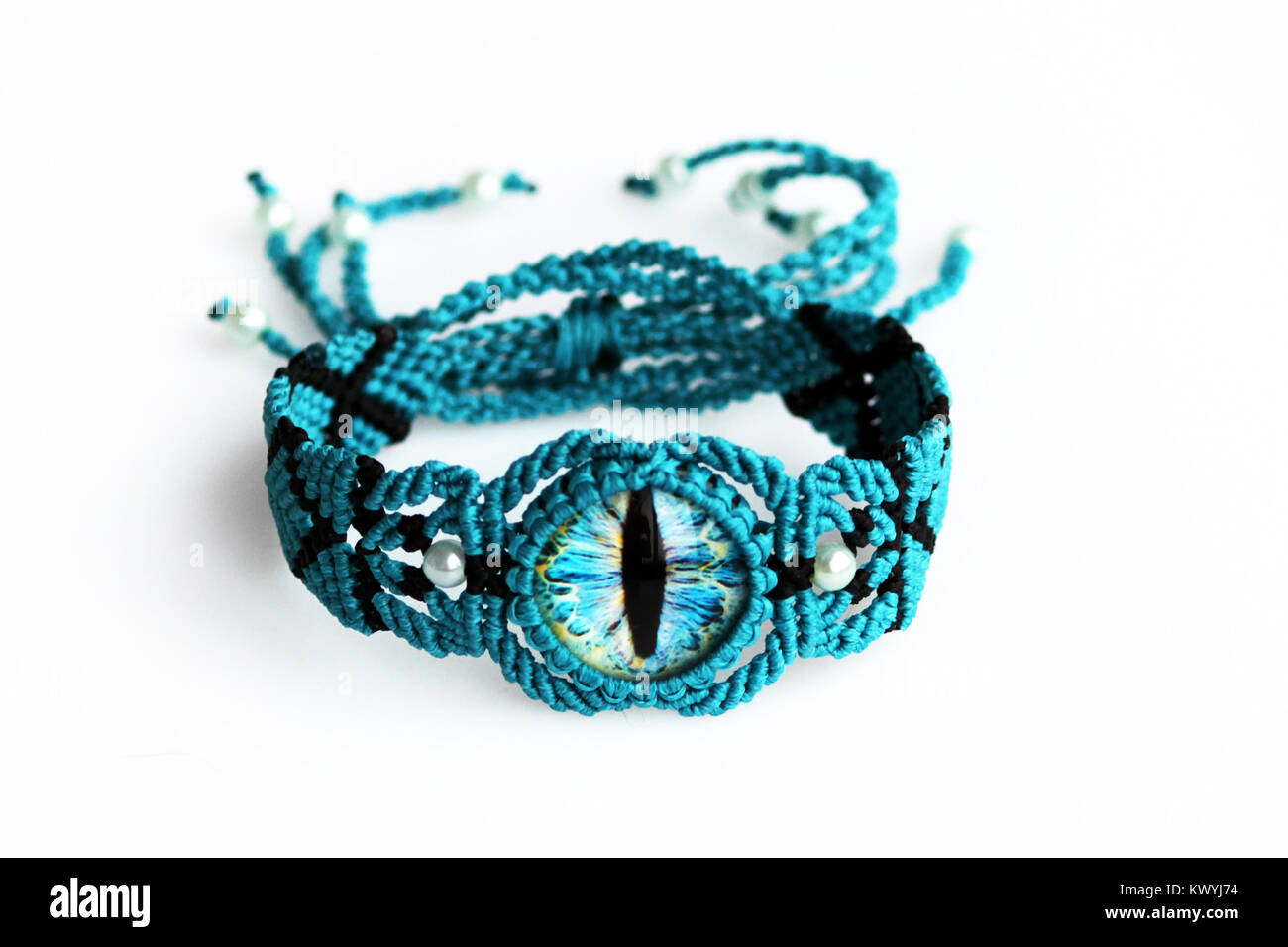 turquoise bracelet for the hand from waxed thread, and dragon eye in the  technique of macrame on a white background Stock Photo - Alamy