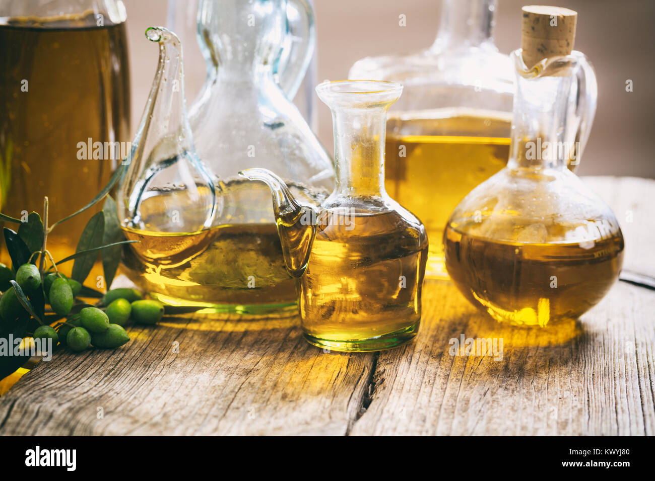 Bottles of olive oil on a wooden table Stock Photo Alamy