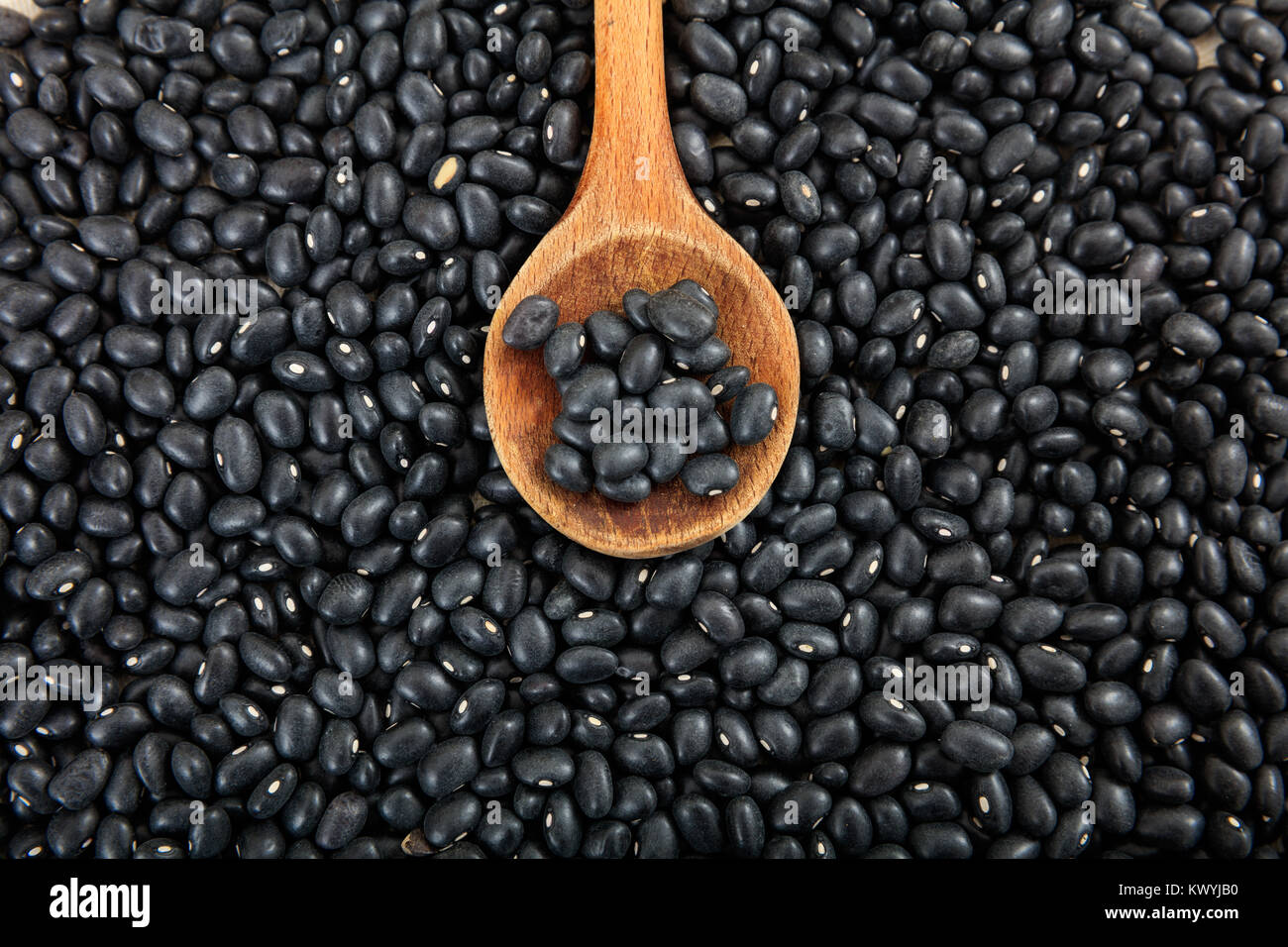 Raw black beans and a wooden ladle Stock Photo Alamy