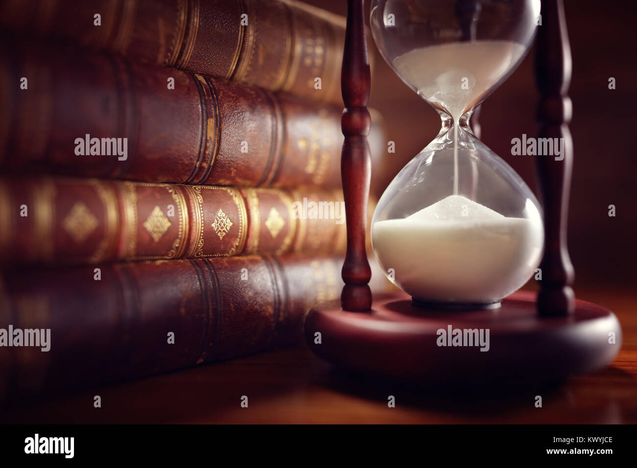 Old books and hourglass in llibrary Stock Photo