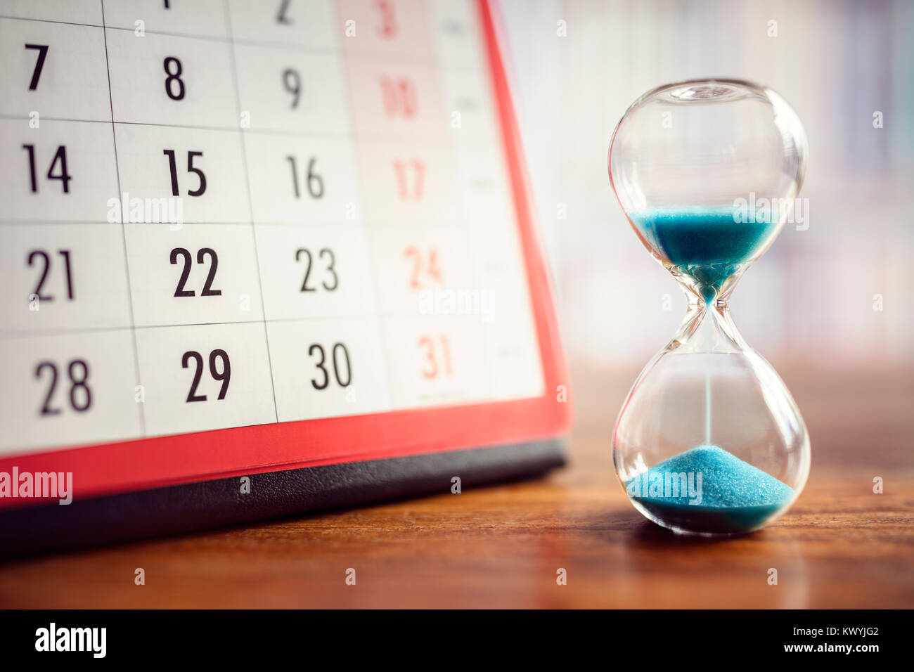 Hour glass and calendar concept for time slipping away for important appointment date, schedule and deadline Stock Photo