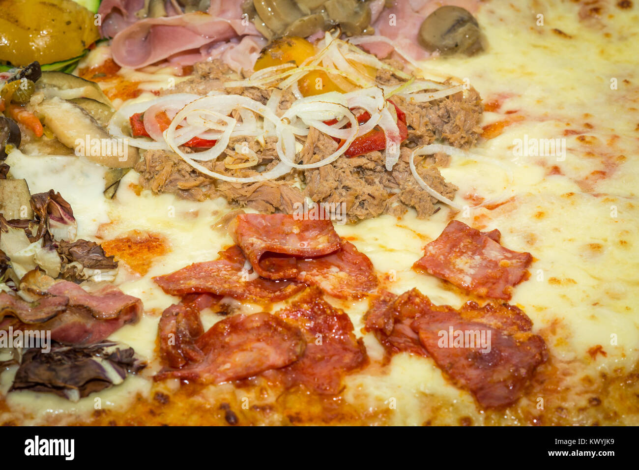 Rectangular shape and thick hand made focaccia pizza. Close-up. Food, italian cuisine and cooking concept. Preparation of the Italian Pizza Stock Photo