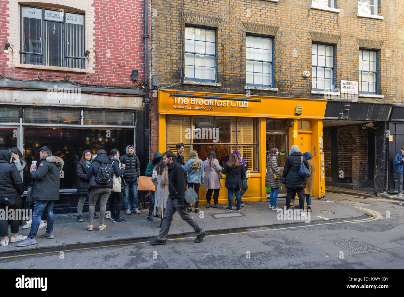 Young people queuing for entry to The Breakfast Club, D'Arblay Street, Soho, London, England. Stock Photo