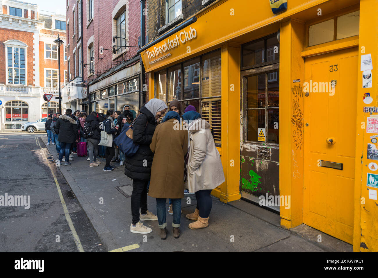 Young people queuing for entry to The Breakfast Club, D'Arblay Street, Soho, London, England. Stock Photo