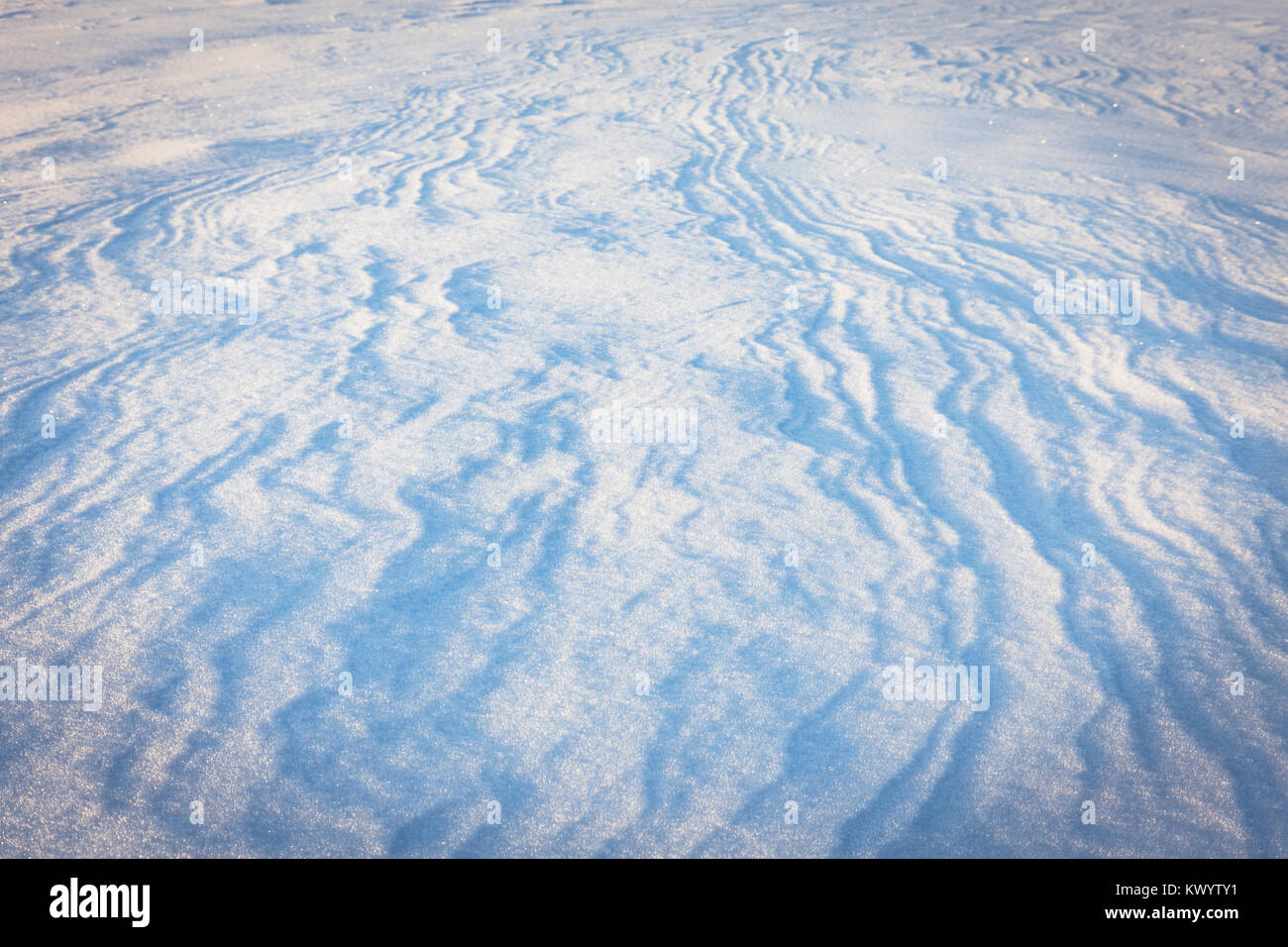 Abstract wind patterns on fresh snow in light of sunrising sun Stock ...