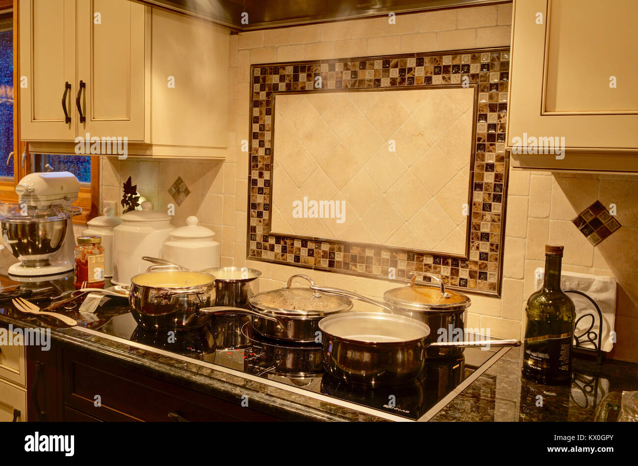 The use of an induction stove in a modern home kitchen. Stock Photo