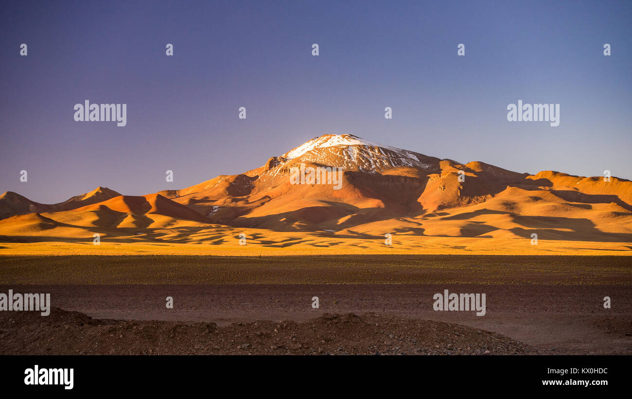 High altitude barren highlands of the Andes, among the most important travel destination in Bolivia.Majestic volcano range in the background. Stock Photo