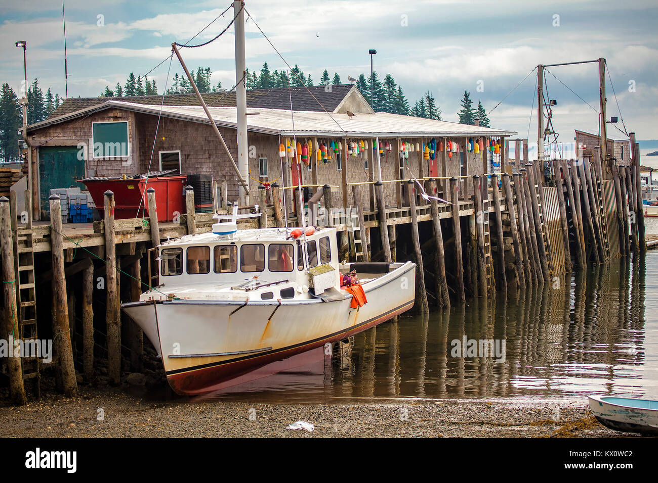 Lobster fishing trawler dry docked at a pier during low tide in Owl's Head, Maine, USA. Stock Photo