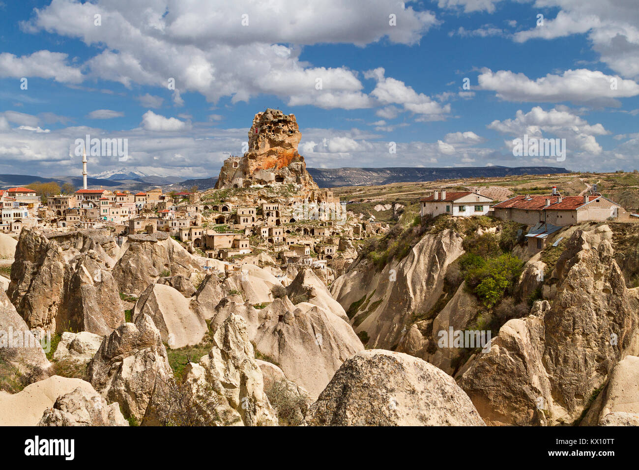 View over the town of Ortahisar and cave dwellings with the Mount Erciyes in the background, in Cappadocia, Turkey. Stock Photo