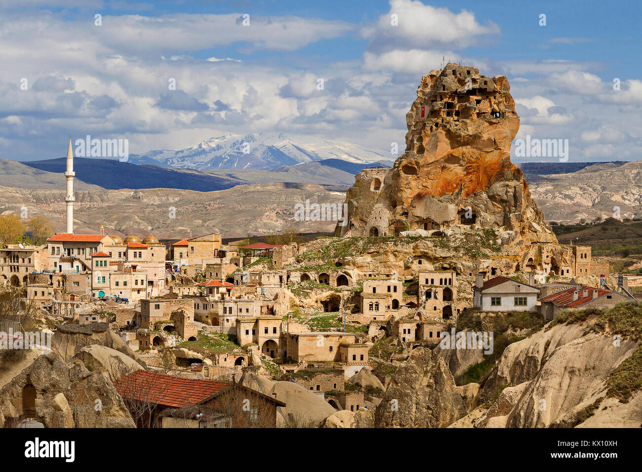 View over the town of Ortahisar and cave dwellings with the Mount Erciyes in the background, in Cappadocia, Turkey. Stock Photo