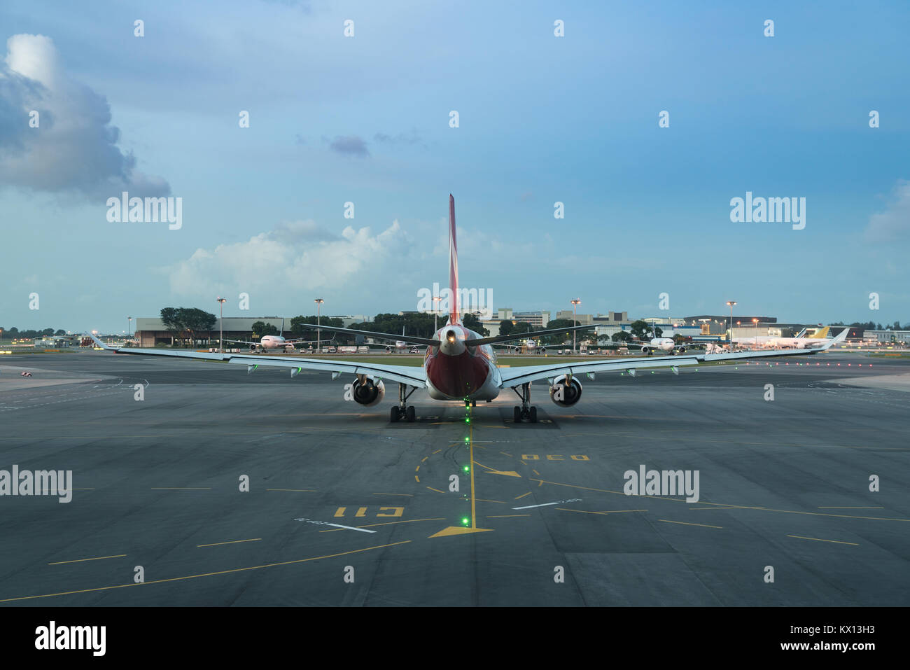 Passengers airplane prepare to airport runway in beautiful twilight in international airport. Stock Photo