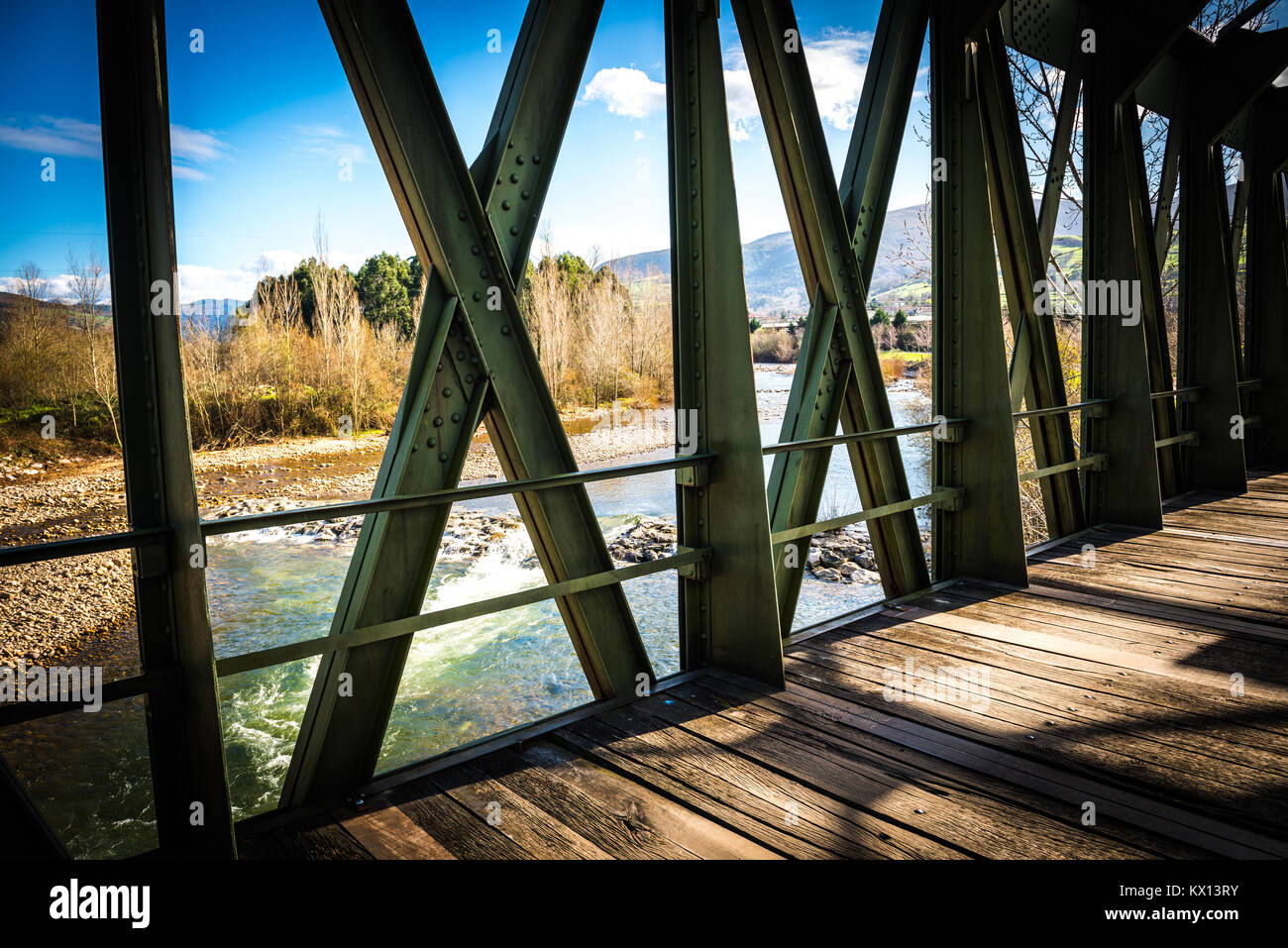 Rickety bridge over river Stock Photo
