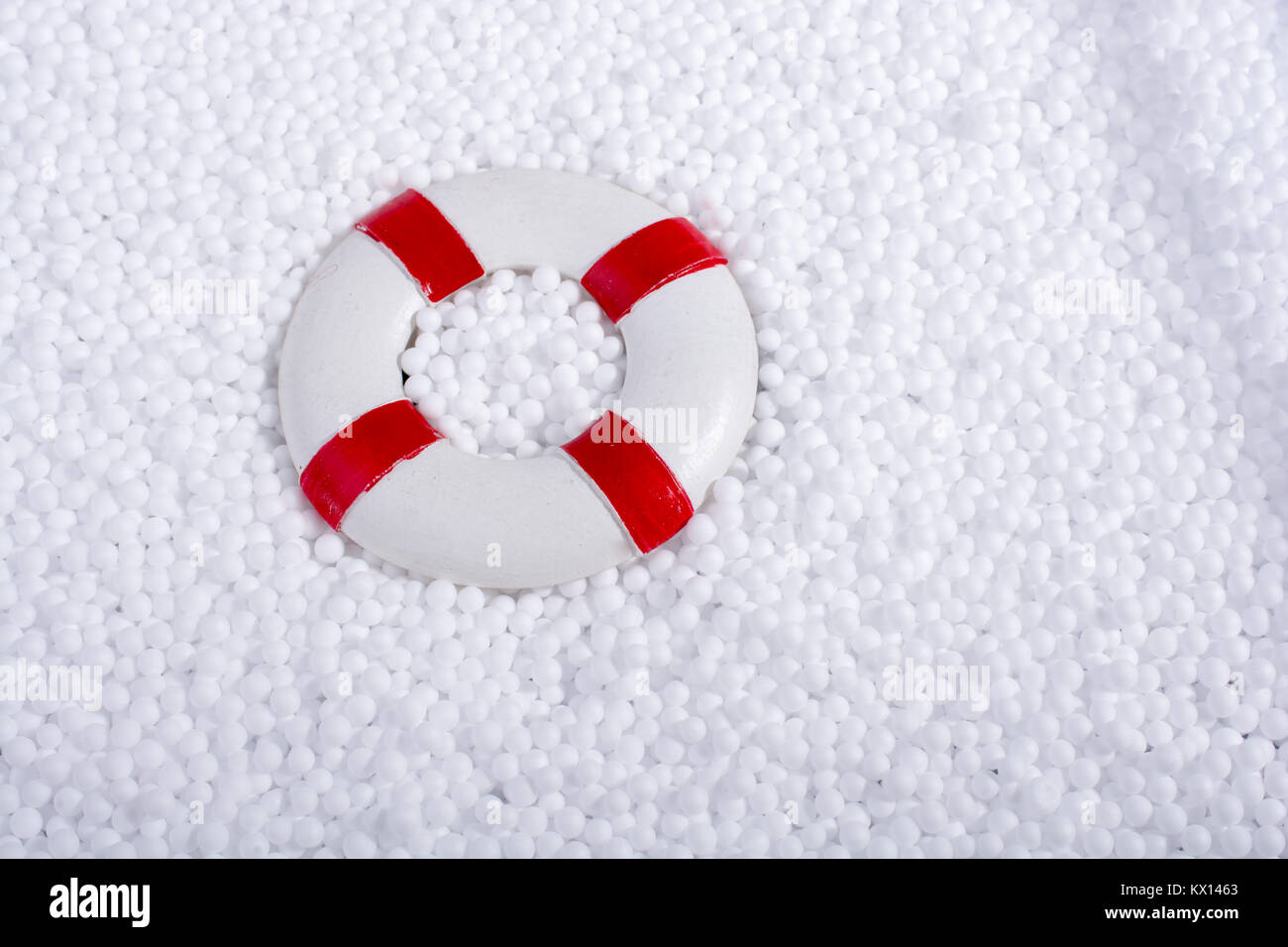 lifesaver on little white polystyrene foam balls Stock Photo - Alamy