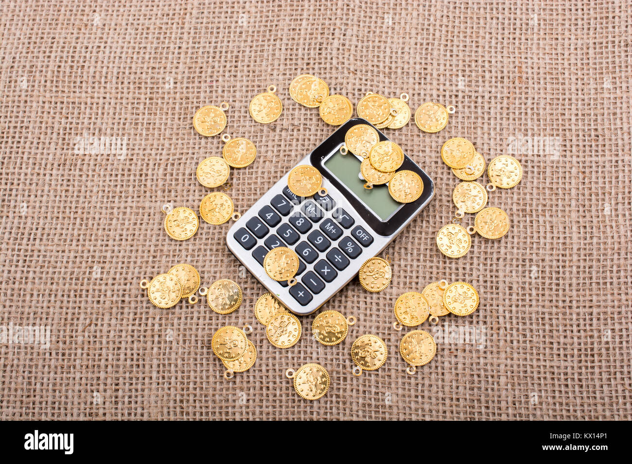fake-gold-coins-around-the-calculator-on-canvas-stock-photo-alamy