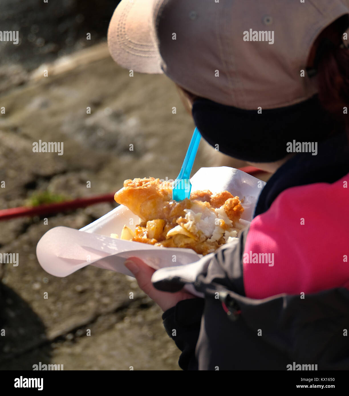 Eating fish and chips outdoors. Fast food. Stock Photo
