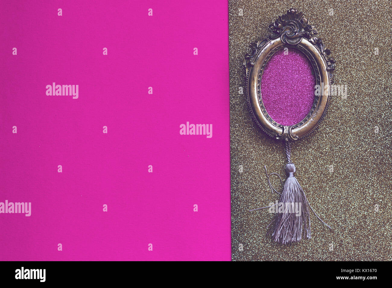 Baroque oval golden picture frame on pink and golden background with