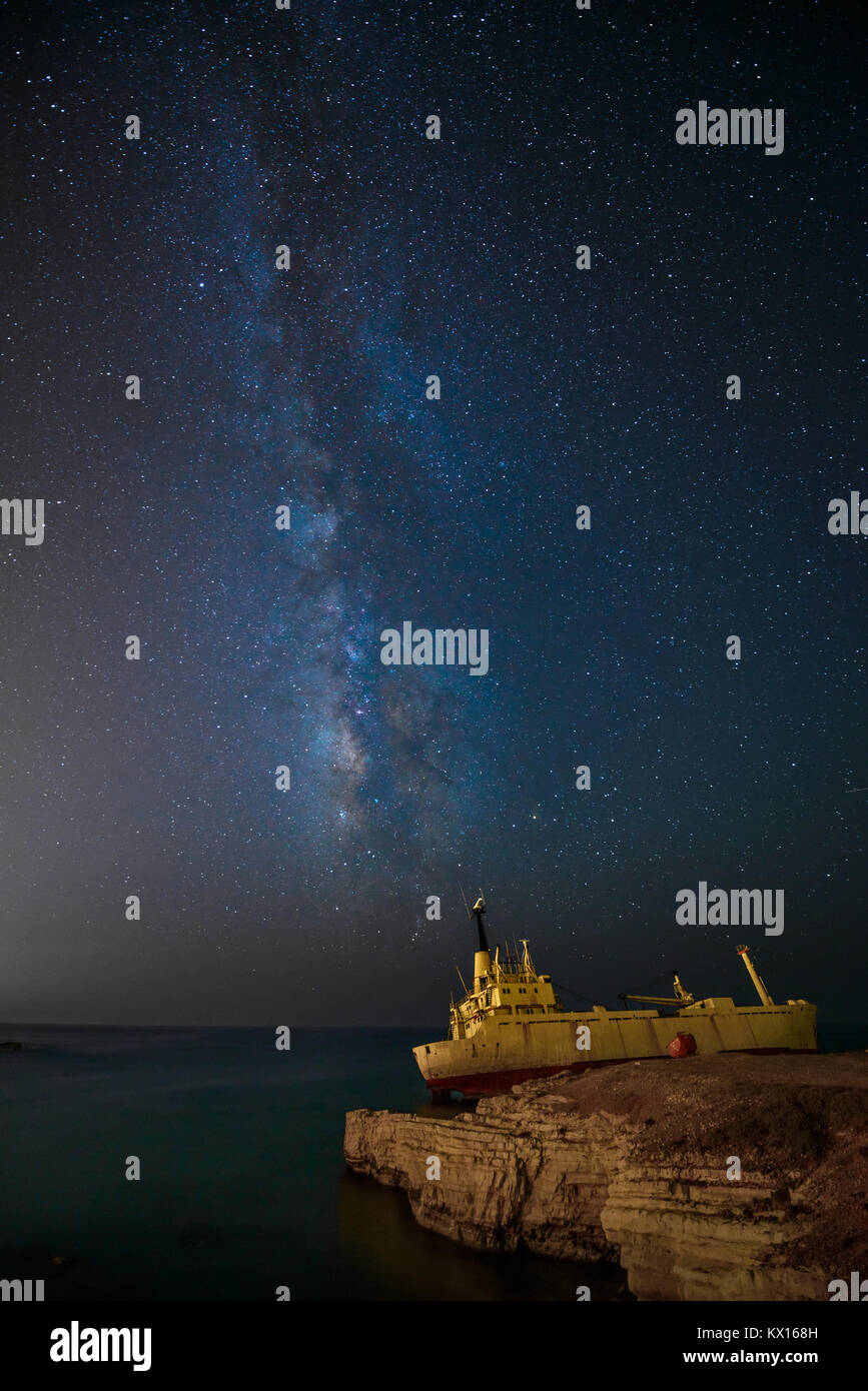 Night sky with the Milky Way and cargoship aground near sea shore Stock ...