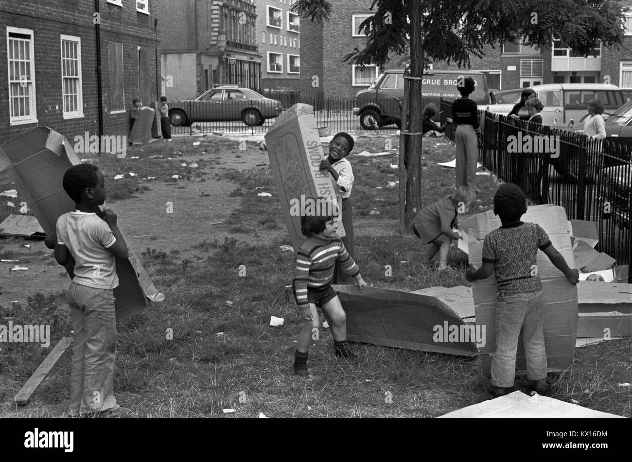 Black British boys playing outside with white boy multi ethnic Britain 1970s  They are on their council estate South London 1975 Britain  70s UK HOMER SYKES Stock Photo