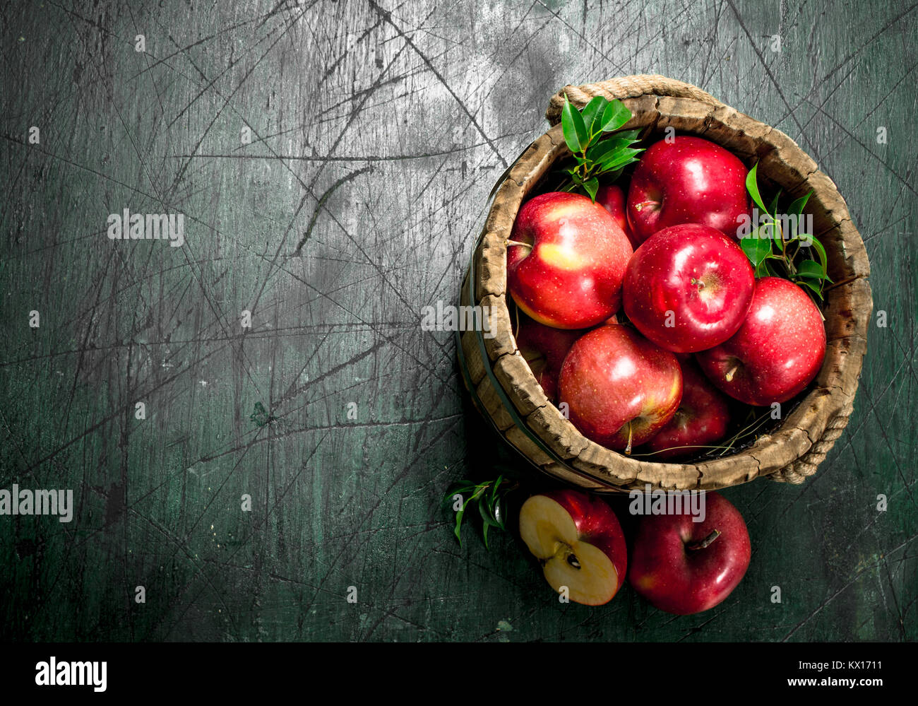Red apples in a wooden bucket. On a rustic background Stock Photo - Alamy
