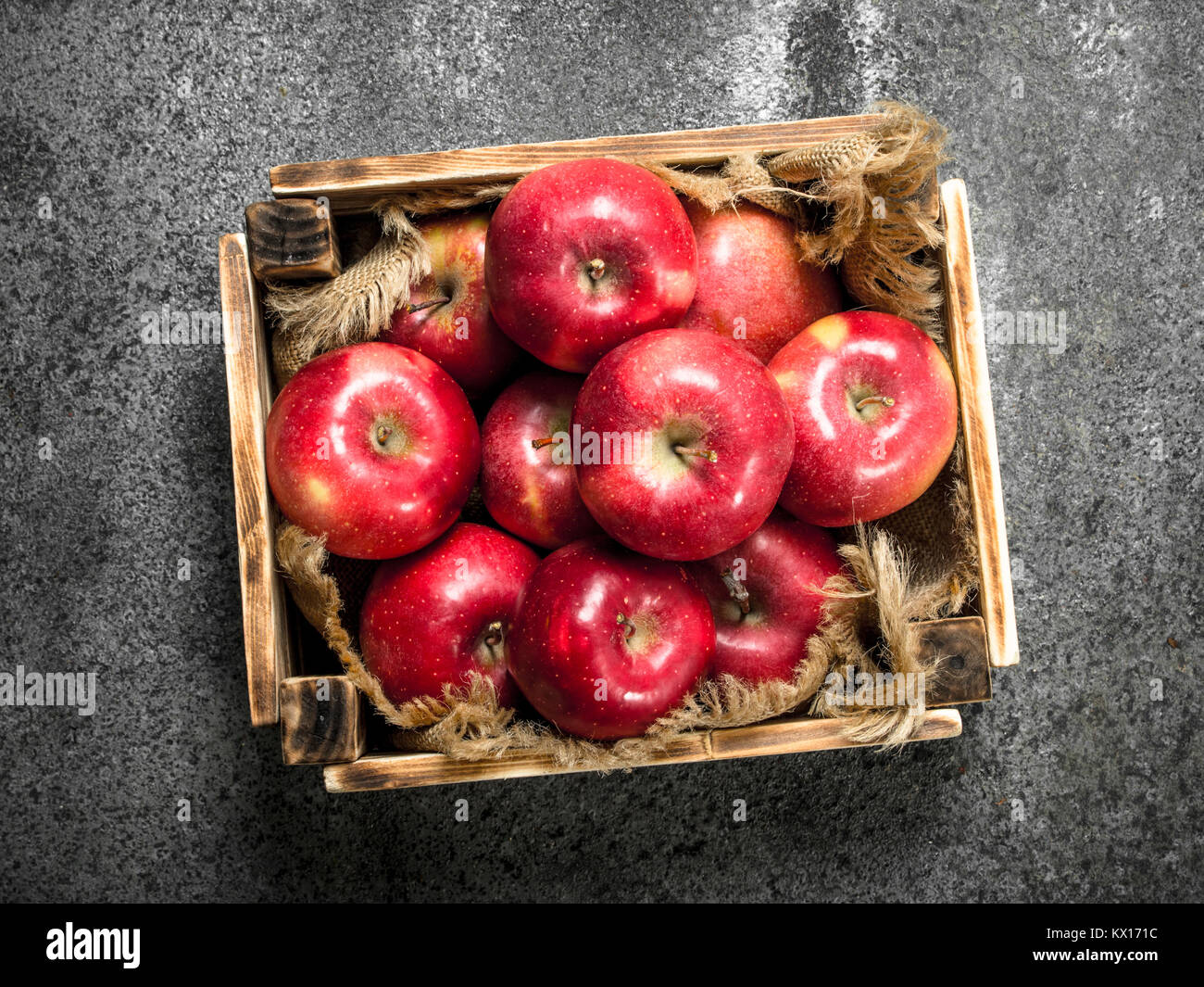 box with ripe red apples. On a rustic background Stock Photo - Alamy