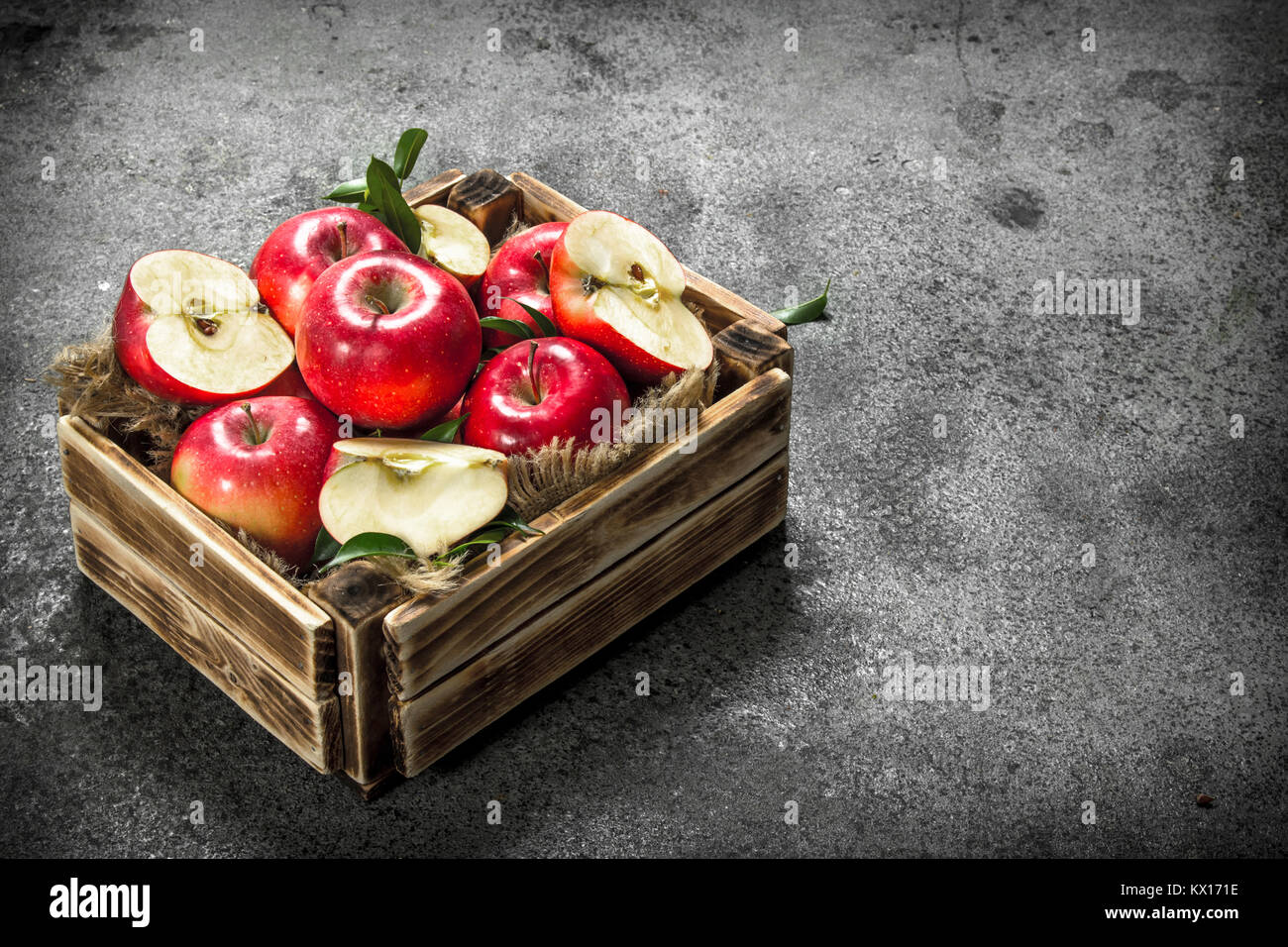 box with ripe red apples. On a rustic background Stock Photo - Alamy