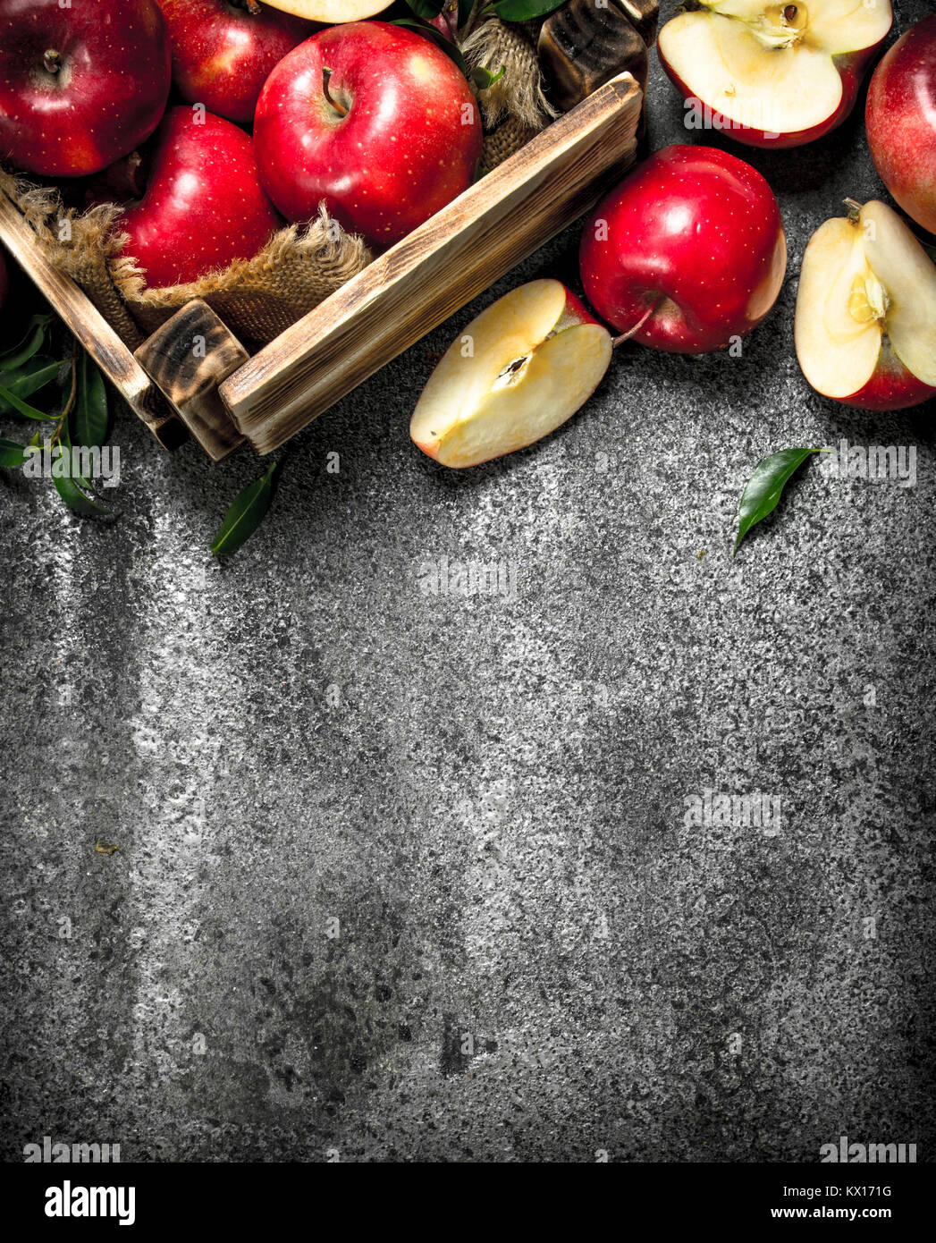 box with ripe red apples. On a rustic background Stock Photo - Alamy