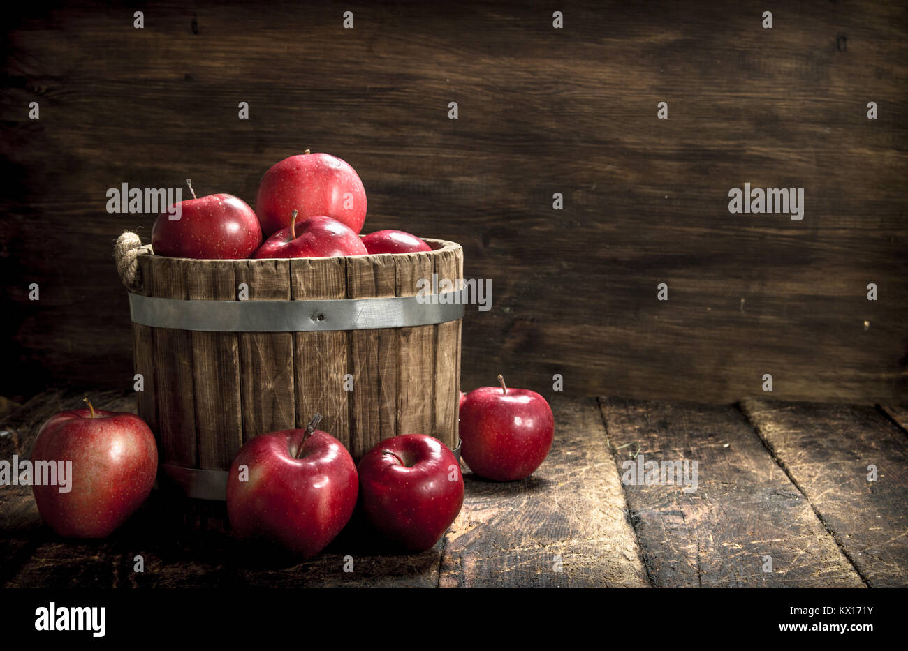 Red ripe apples in a wooden bucket. On a wooden background Stock Photo ...