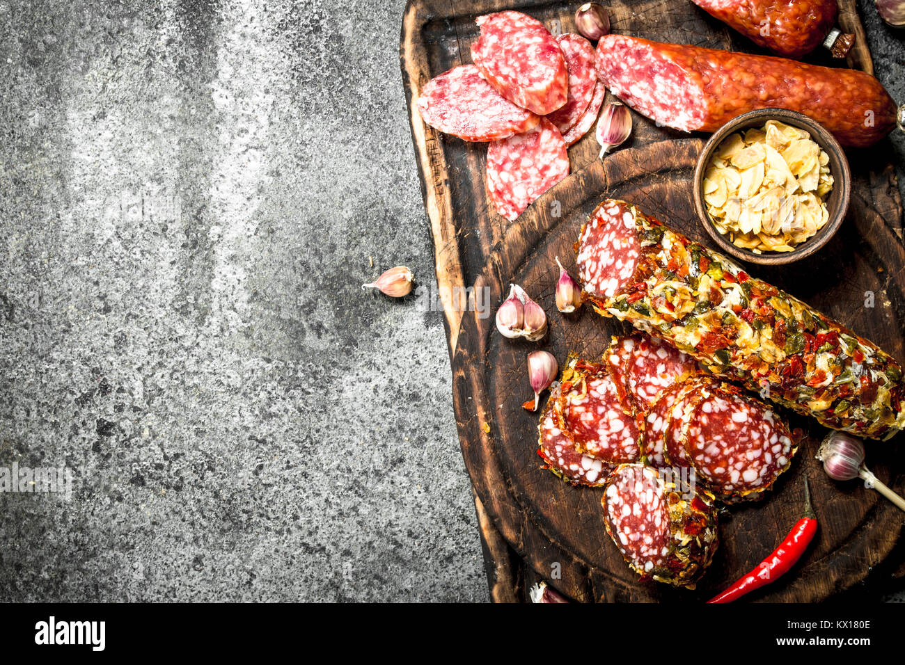 variety of salami with spices and herbs. On a rustic background Stock ...