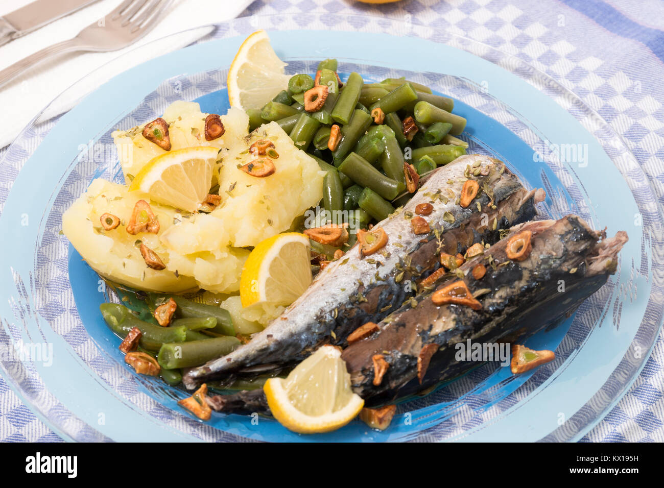 Homemade portuguese mackerel fish meal with potatoes and veggies. Stock Photo