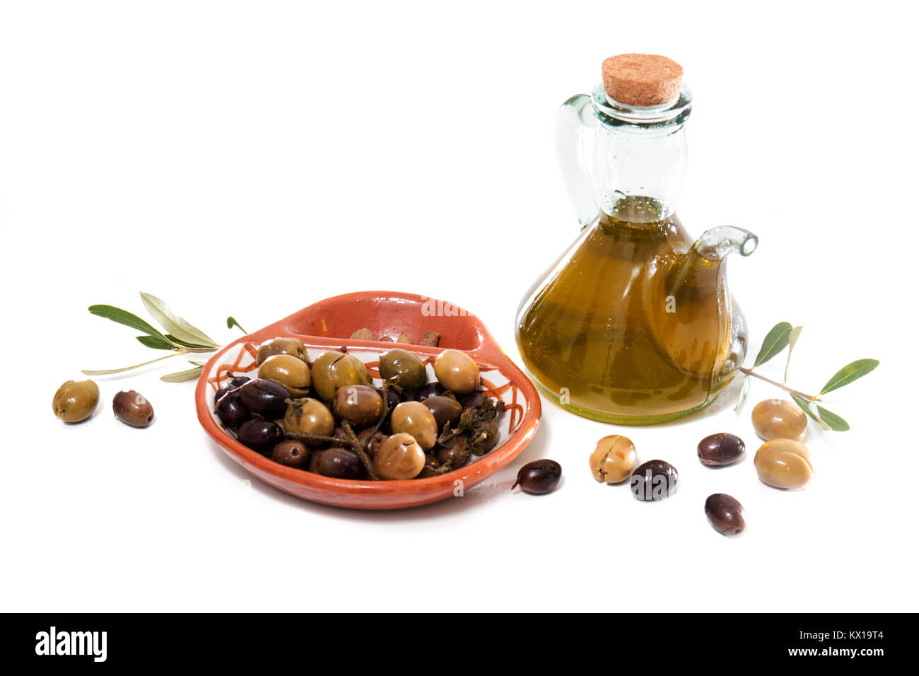 Green and black olives with olive oil bottle isolated on a white ...