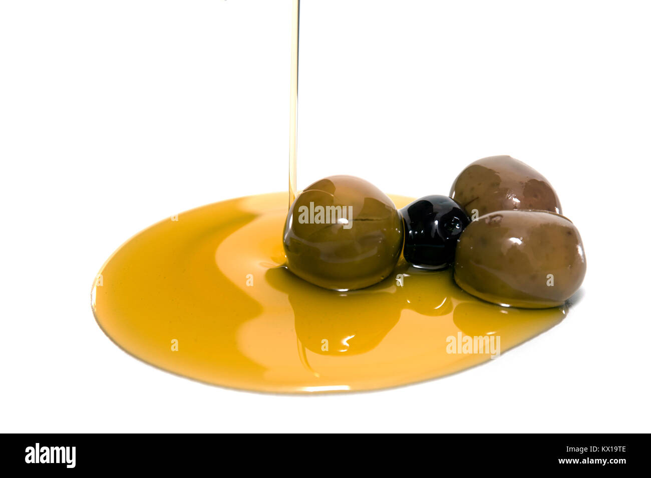 Green and black olives with olive oil spill isolated on a white