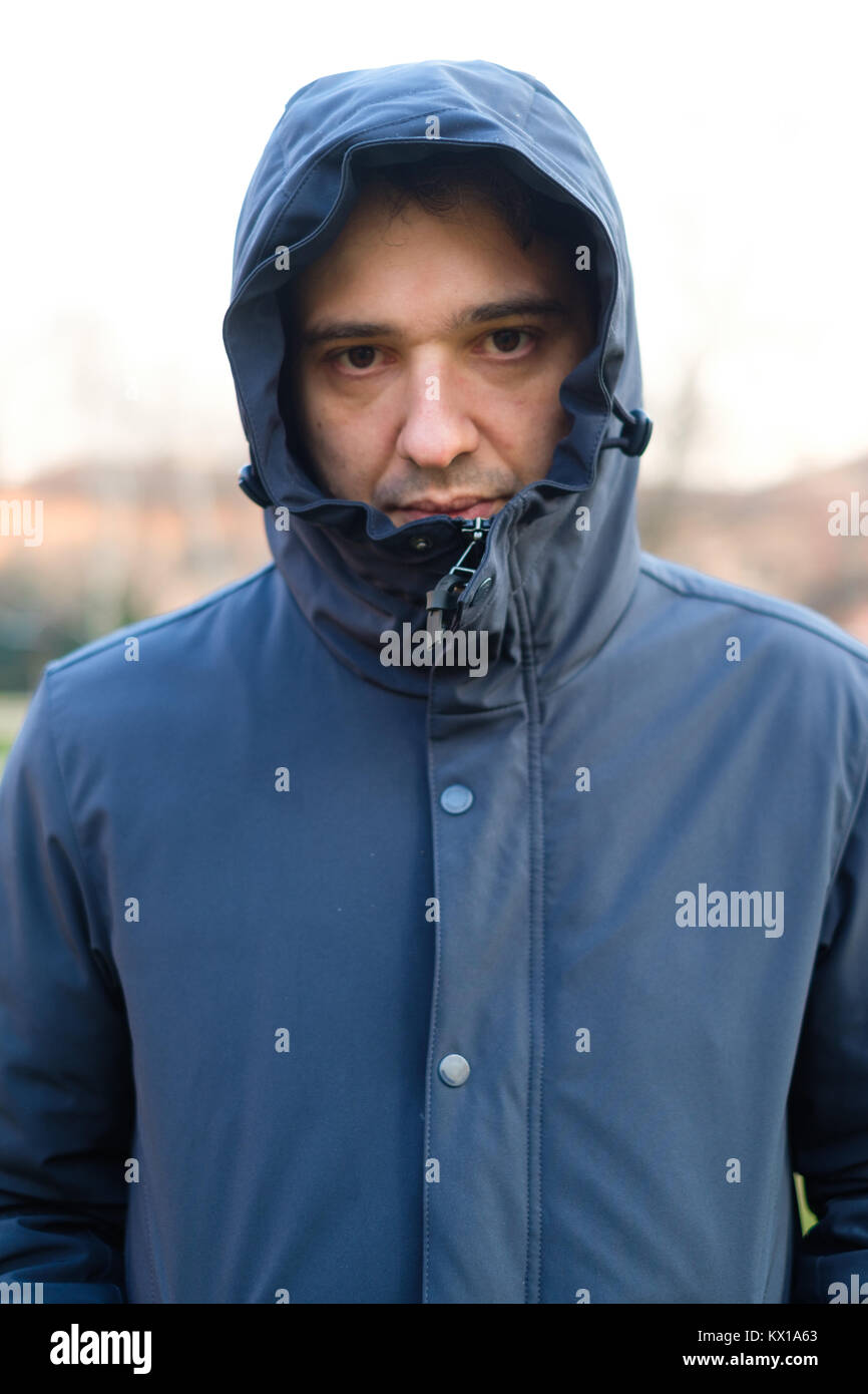 Face portrait of a man dressed in warm clothes feeling cold Stock Photo