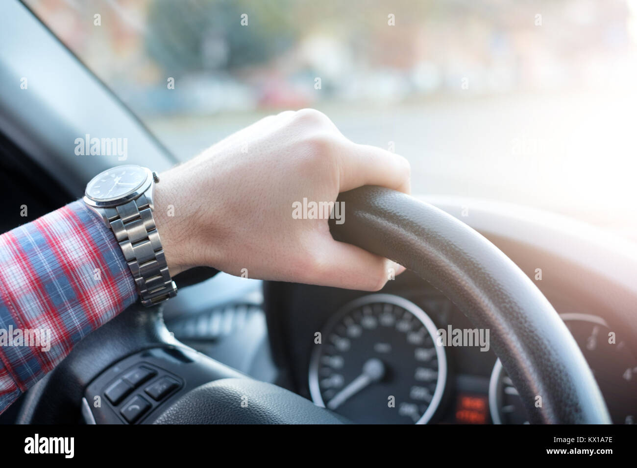 Hand on the wheel of one man driving his car Stock Photo Alamy
