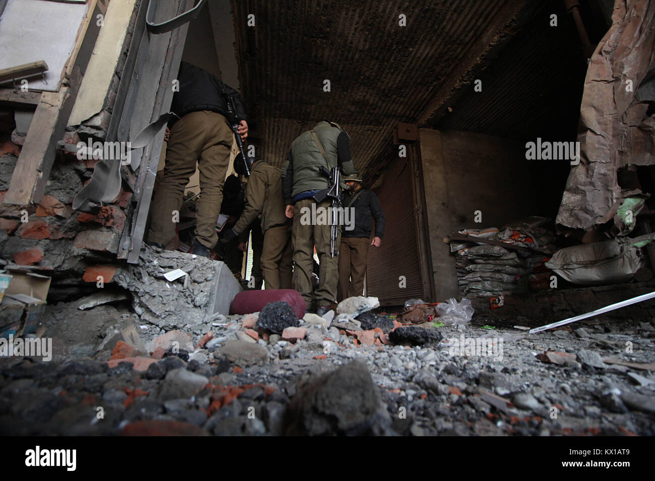 India. 06th Jan, 2018. Indian policemen stand near the site of blast in north Kashmir's Sopore town some 45 kilometers from Srinagar the summer capital of Indian controlled Kashmir on January 06, 2018. Four Indian policemen were killed when suspected rebels triggered an IED (improvised explosive device) in Sopore north of Srinagar. Credit: Faisal Khan/Pacific Press/Alamy Live News Stock Photo