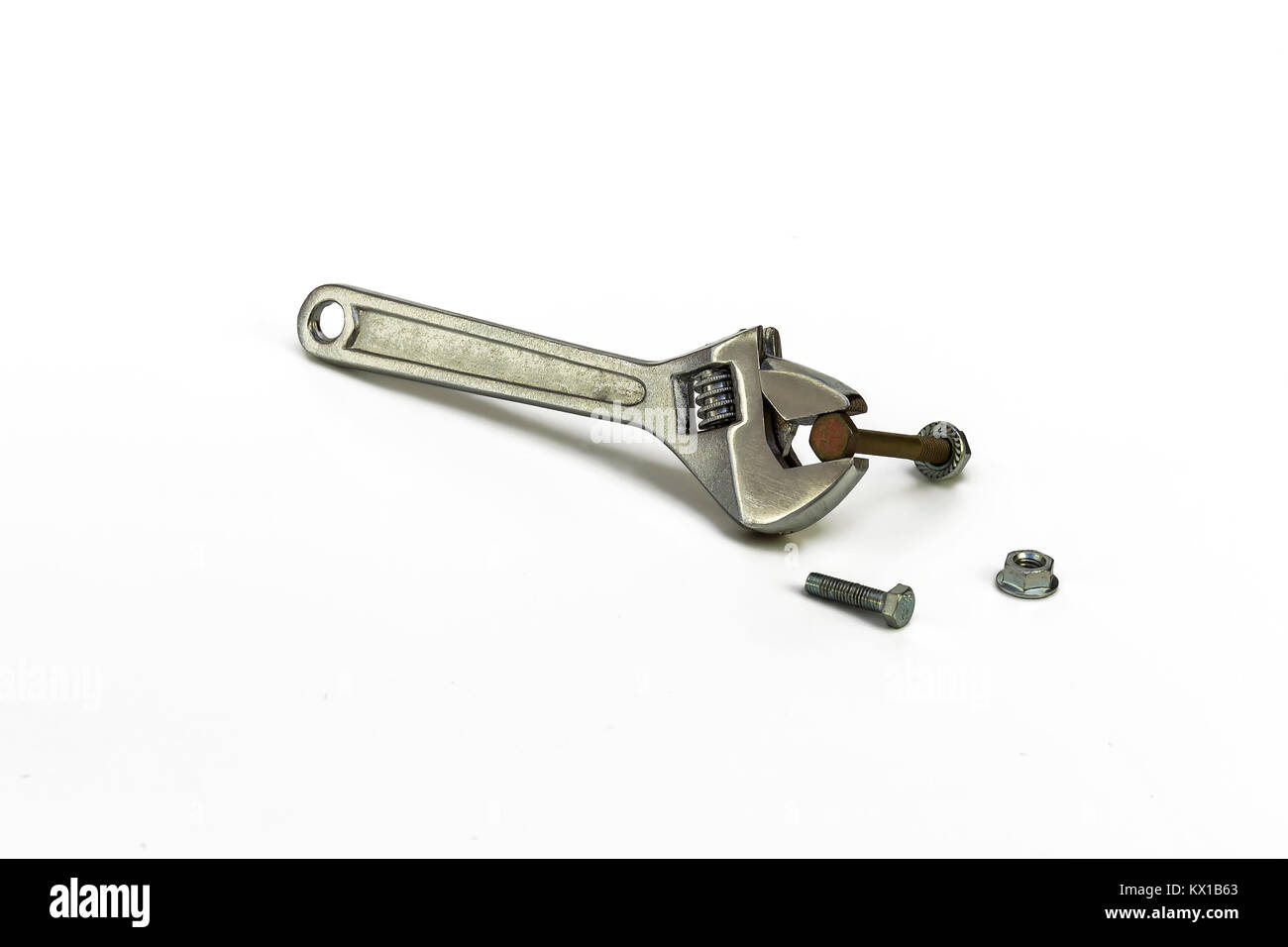 On a white background a metal adjustable wrench clamps a bolt with a